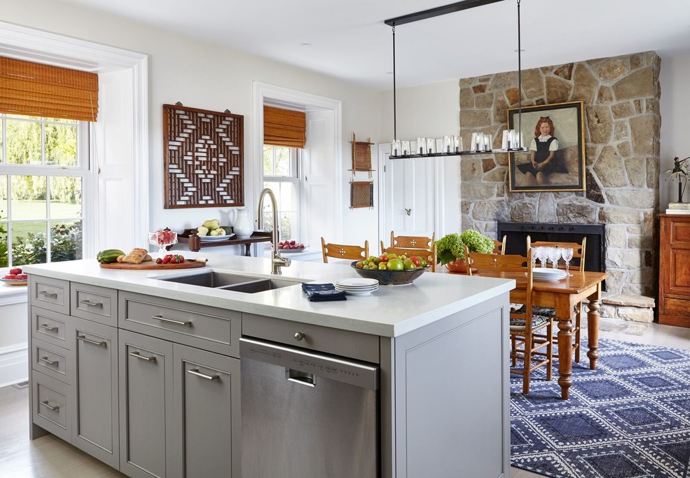 Small elegant galley light wood floor eat-in kitchen photo in Other with recessed-panel cabinets, gray cabinets, solid surface countertops, a double-bowl sink, stainless steel appliances and an island
