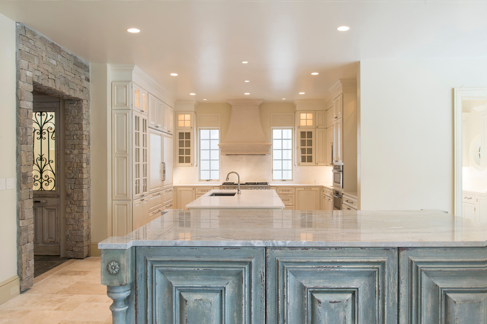 Large elegant u-shaped beige floor and travertine floor eat-in kitchen photo in DC Metro with an undermount sink, marble countertops, white backsplash, marble backsplash, paneled appliances, two islands, raised-panel cabinets and white cabinets