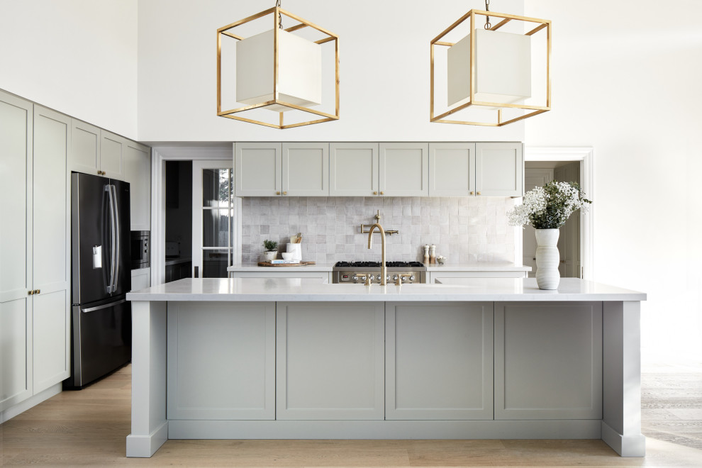 Inspiration for a classic kitchen in Sydney with a belfast sink, shaker cabinets, green cabinets, engineered stone countertops, mosaic tiled splashback and light hardwood flooring.