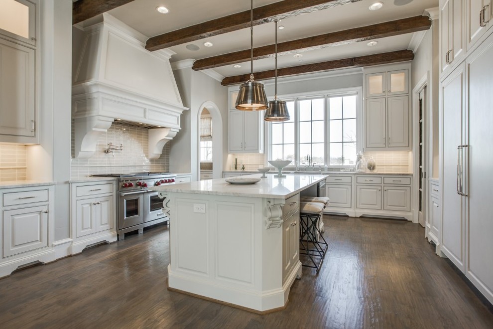 Inspiration for a huge transitional u-shaped medium tone wood floor and brown floor eat-in kitchen remodel in Dallas with a farmhouse sink, beaded inset cabinets, white cabinets, marble countertops, white backsplash, glass tile backsplash, stainless steel appliances and an island
