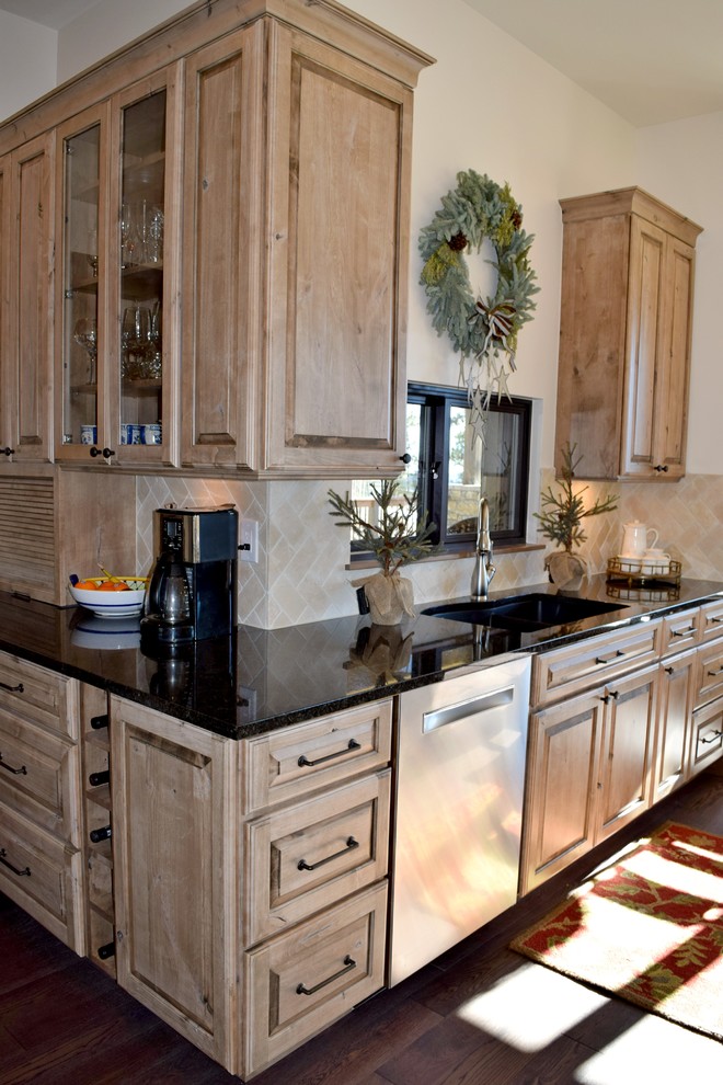 This is an example of a rustic l-shaped open plan kitchen in Denver with a submerged sink, raised-panel cabinets, distressed cabinets, white splashback, stainless steel appliances, dark hardwood flooring and an island.