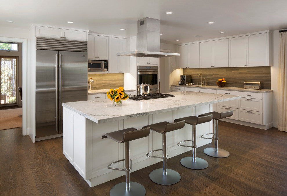 Transitional u-shaped dark wood floor eat-in kitchen photo in San Francisco with recessed-panel cabinets, white cabinets, granite countertops, green backsplash, stone tile backsplash, stainless steel appliances and an island