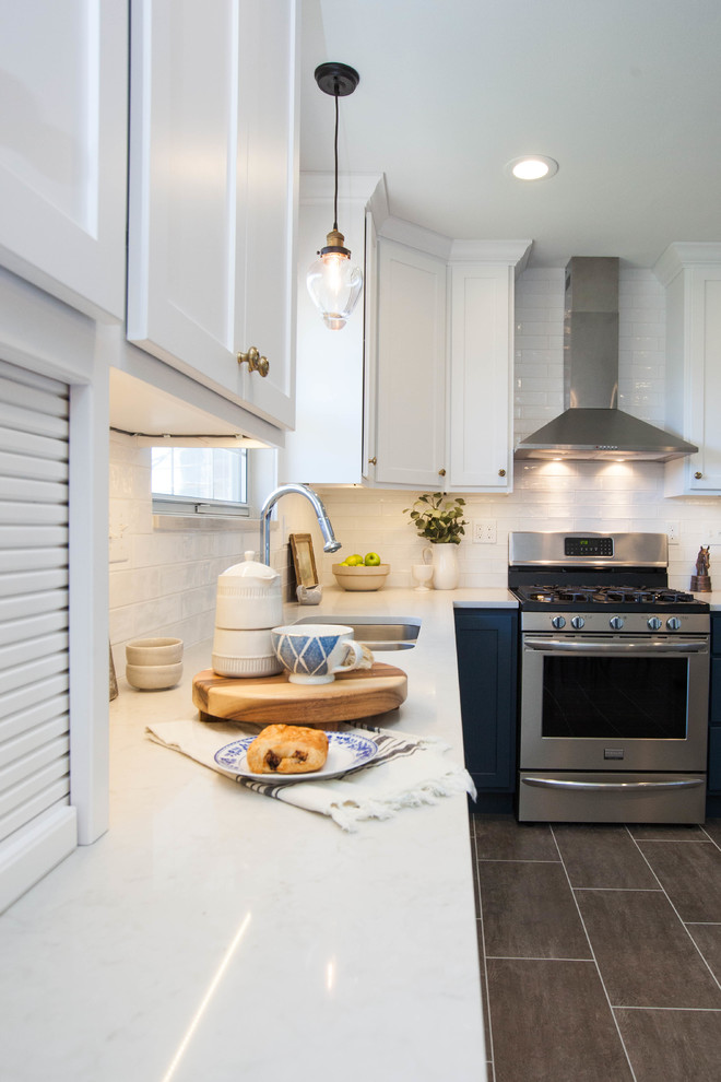 Mid-sized trendy l-shaped vinyl floor and gray floor eat-in kitchen photo in St Louis with an undermount sink, shaker cabinets, blue cabinets, quartz countertops, white backsplash, ceramic backsplash, stainless steel appliances and no island
