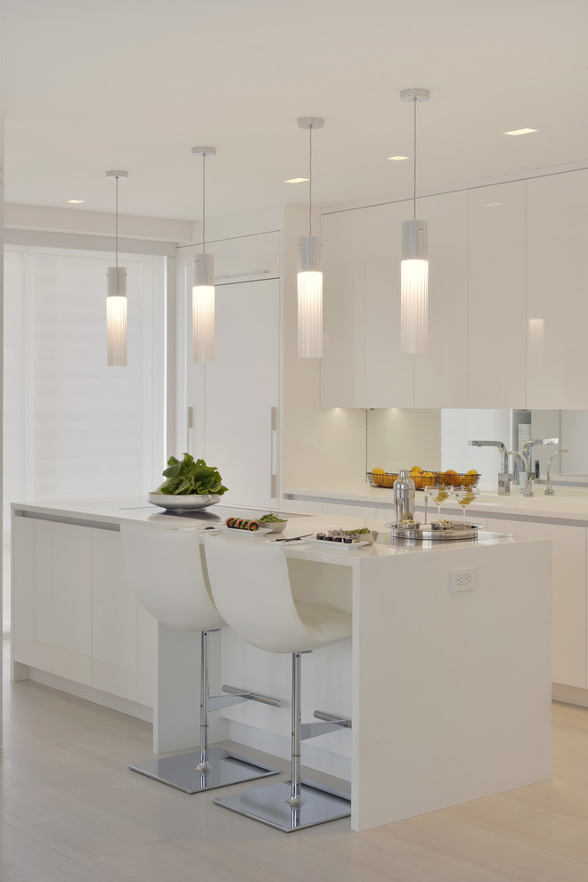 Inspiration for a small contemporary l-shaped porcelain tile and beige floor enclosed kitchen remodel in New York with an integrated sink, flat-panel cabinets, white cabinets, solid surface countertops, mirror backsplash, white appliances and an island