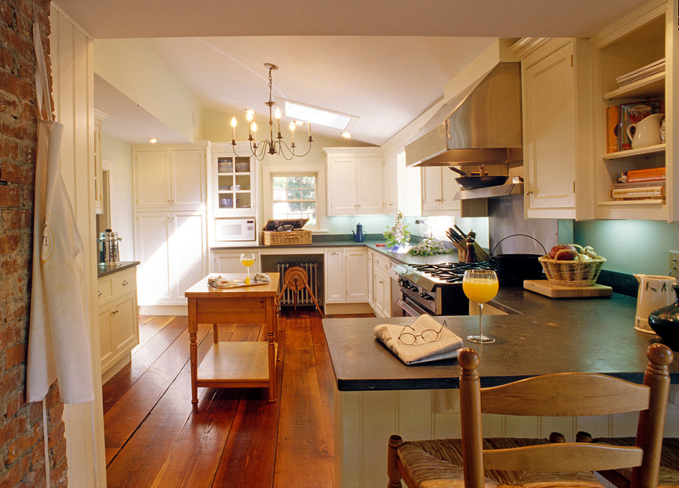 Example of a classic eat-in kitchen design in New York with recessed-panel cabinets, white cabinets, soapstone countertops and stainless steel appliances