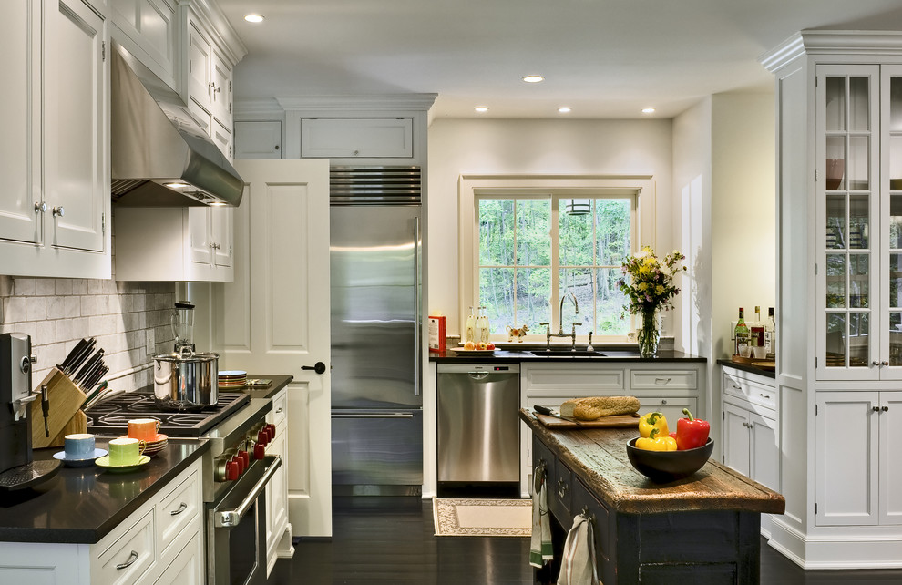 Inspiration for a timeless l-shaped eat-in kitchen remodel in New York with recessed-panel cabinets, white cabinets, white backsplash, subway tile backsplash, stainless steel appliances, an undermount sink and granite countertops