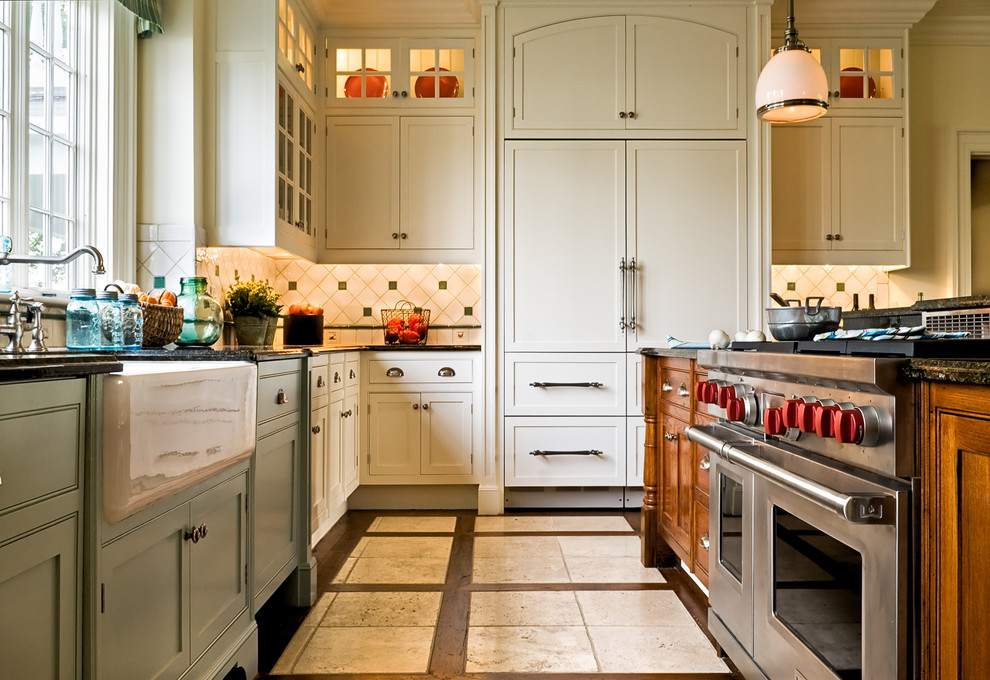 Eat-in kitchen - traditional multicolored floor eat-in kitchen idea in New York with a farmhouse sink, recessed-panel cabinets, white cabinets, granite countertops, paneled appliances, multicolored backsplash and ceramic backsplash
