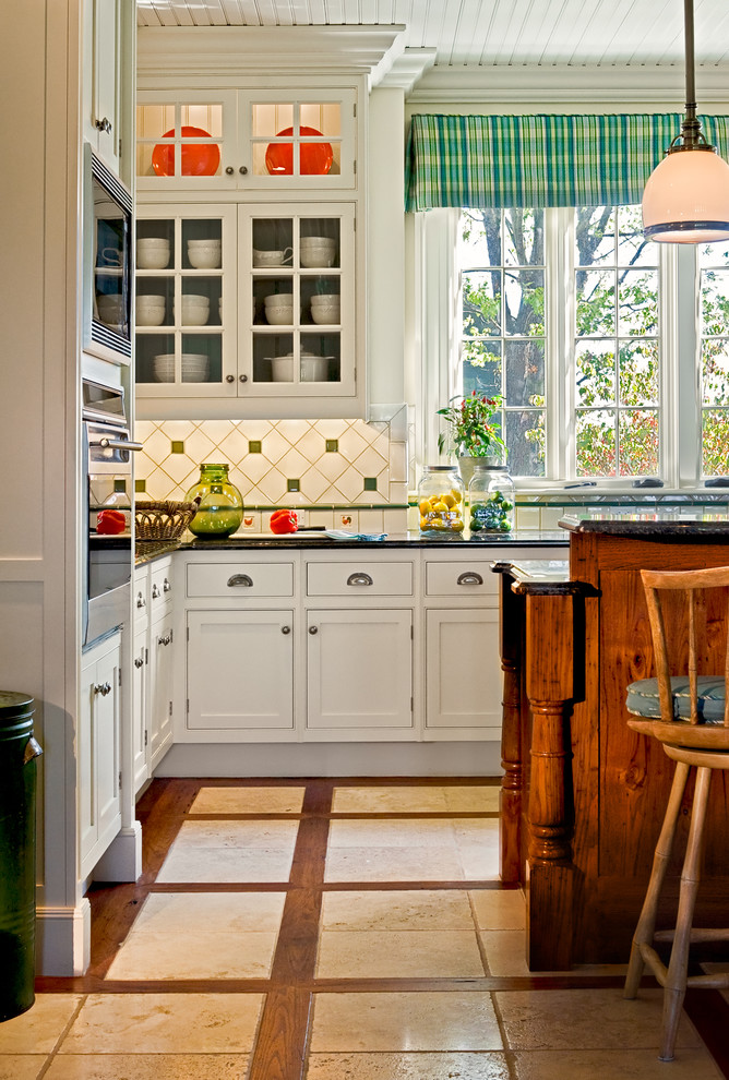 Inspiration for a timeless multicolored floor eat-in kitchen remodel in New York with recessed-panel cabinets, white cabinets, granite countertops, a drop-in sink, multicolored backsplash, ceramic backsplash and stainless steel appliances