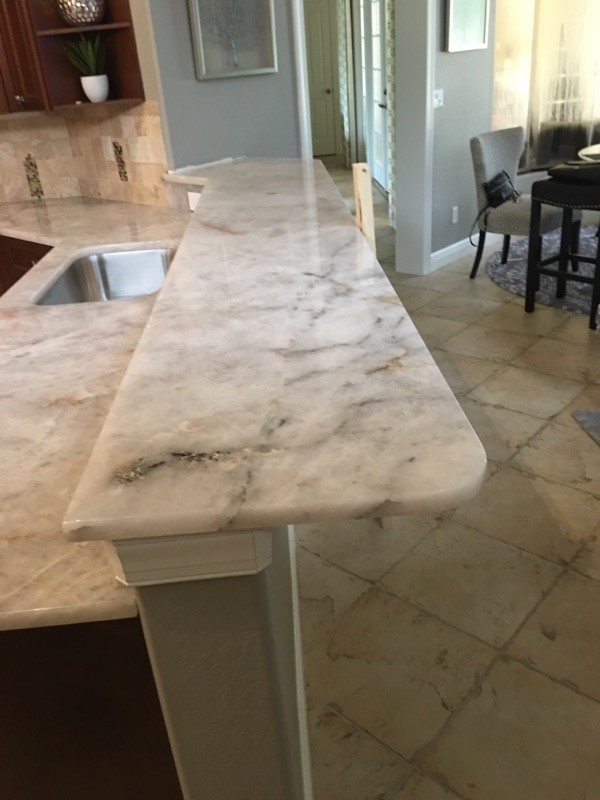 Inspiration for a large classic kitchen in Miami with a submerged sink, raised-panel cabinets, brown cabinets, quartz worktops, beige splashback, marble splashback, marble flooring, an island and beige floors.