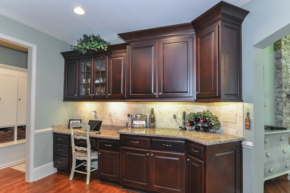 This is an example of a medium sized traditional u-shaped kitchen pantry in Atlanta with a submerged sink, raised-panel cabinets, dark wood cabinets, granite worktops, beige splashback, stone tiled splashback, stainless steel appliances, medium hardwood flooring and multiple islands.