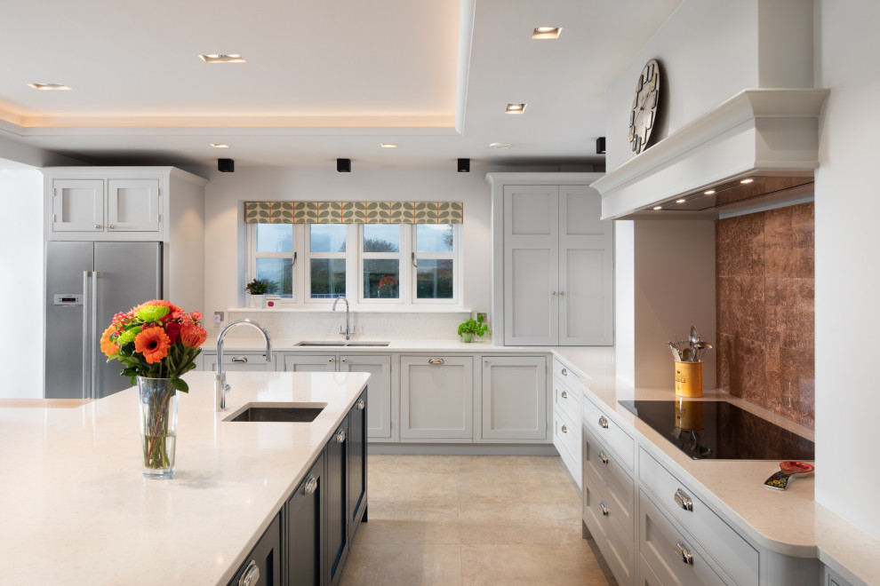 Example of a transitional l-shaped beige floor kitchen design in Other with an undermount sink, shaker cabinets, gray cabinets, stainless steel appliances, an island and white countertops