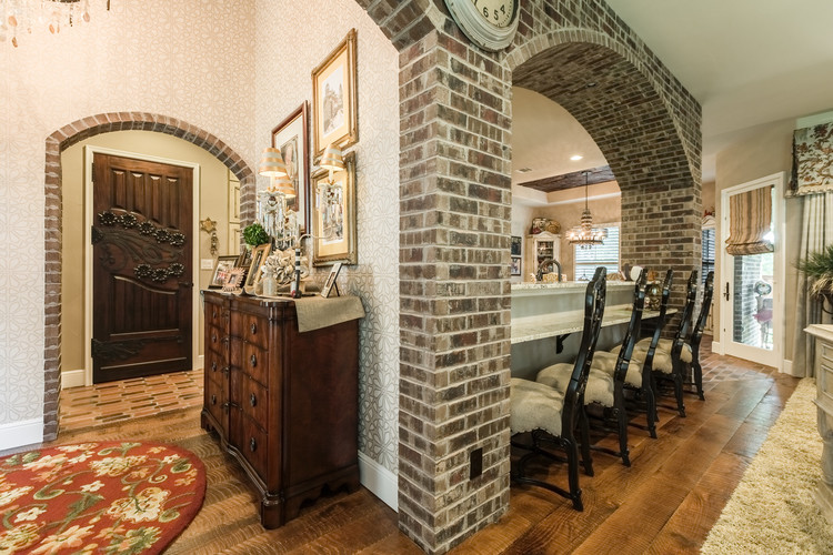 Example of a classic u-shaped brick floor open concept kitchen design in Dallas with beaded inset cabinets, white cabinets, granite countertops, white backsplash, mosaic tile backsplash, stainless steel appliances and an island