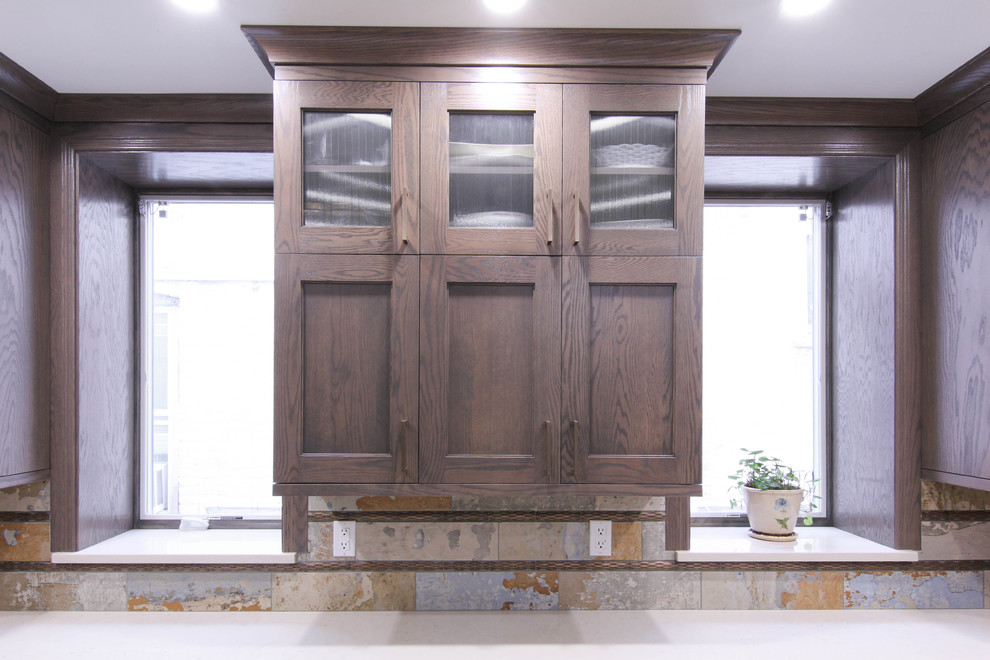 Eat-in kitchen - large rustic u-shaped porcelain tile eat-in kitchen idea in New York with an undermount sink, shaker cabinets, brown cabinets, quartzite countertops, multicolored backsplash, porcelain backsplash, stainless steel appliances and an island