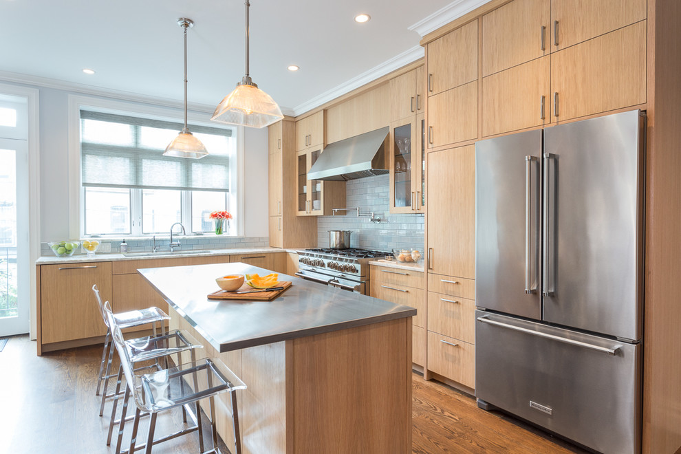 Mid-sized transitional l-shaped medium tone wood floor eat-in kitchen photo in New York with an undermount sink, flat-panel cabinets, light wood cabinets, quartzite countertops, blue backsplash, ceramic backsplash, stainless steel appliances and an island