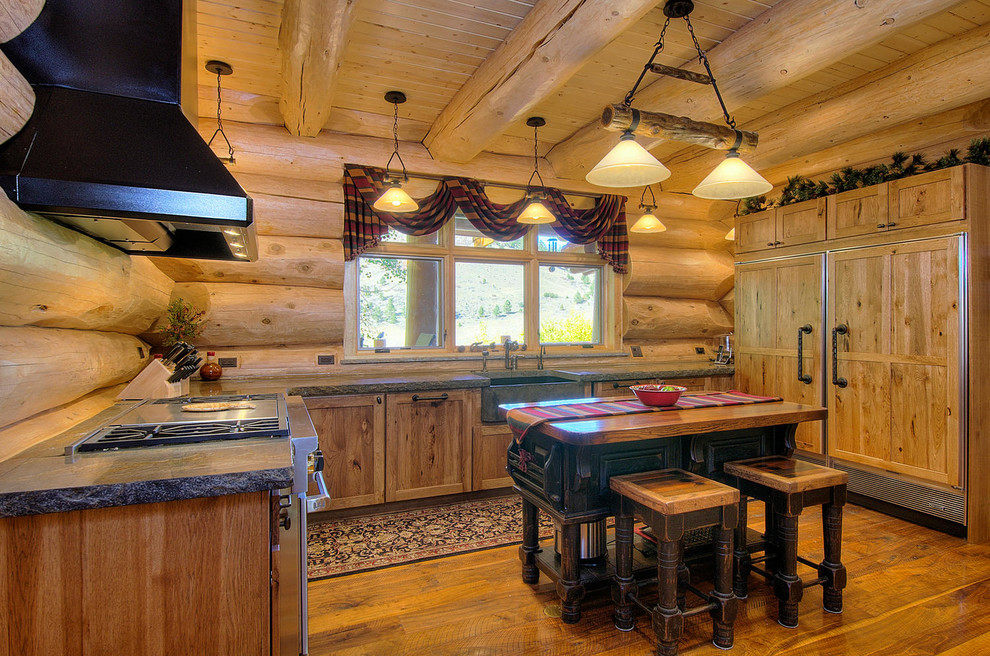 Example of a mid-sized mountain style u-shaped medium tone wood floor and brown floor open concept kitchen design in Denver with shaker cabinets, light wood cabinets, an island, a farmhouse sink, granite countertops, brown backsplash, wood backsplash, paneled appliances and gray countertops