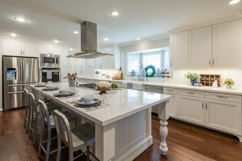 Design ideas for a large rural l-shaped open plan kitchen in Houston with a belfast sink, shaker cabinets, white cabinets, engineered stone countertops, blue splashback, ceramic splashback, stainless steel appliances, medium hardwood flooring and an island.