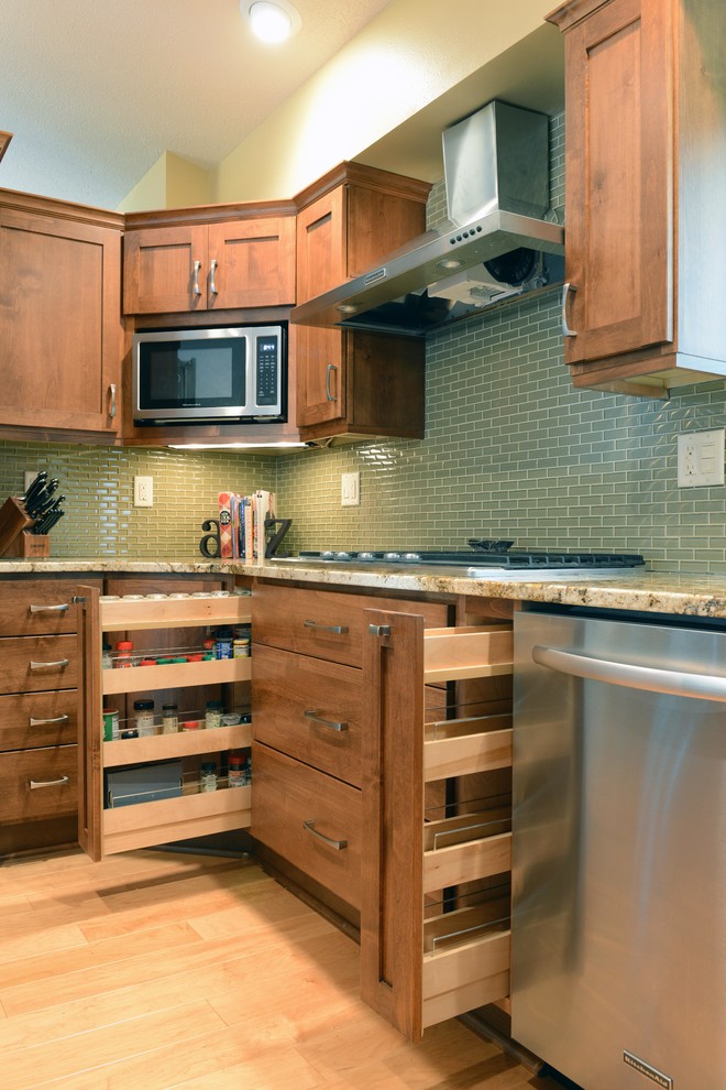 Example of a mid-sized transitional u-shaped light wood floor open concept kitchen design in Other with an undermount sink, shaker cabinets, medium tone wood cabinets, granite countertops, glass tile backsplash, stainless steel appliances and an island