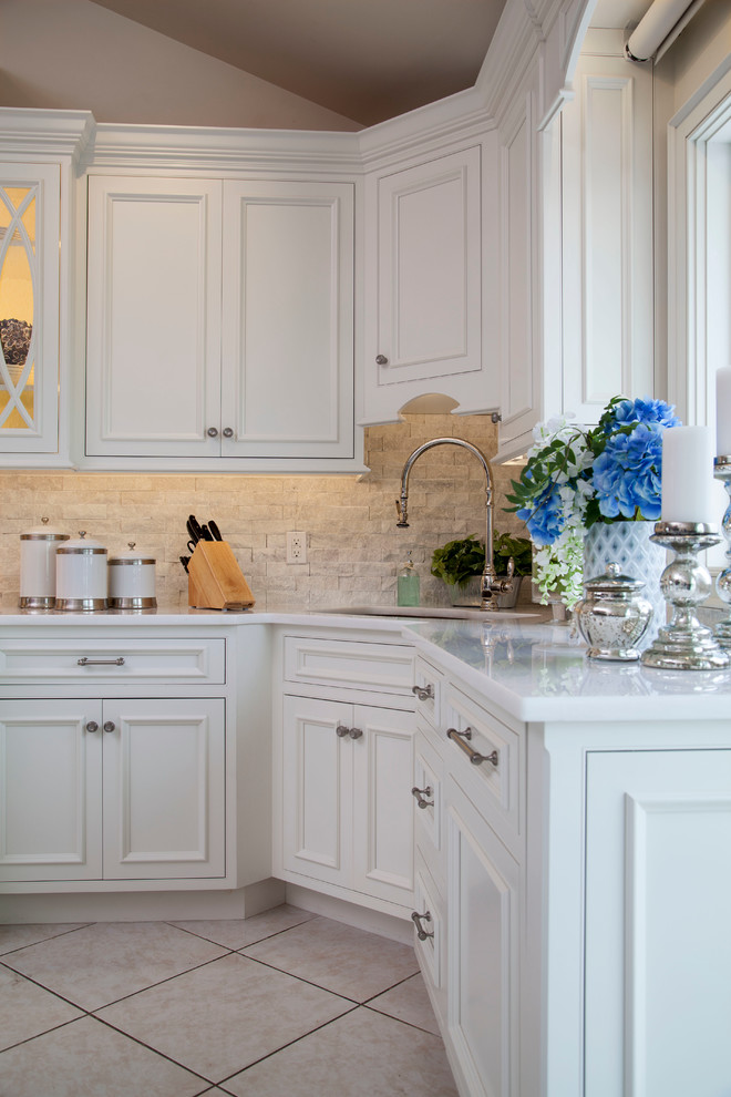 Inspiration for a large transitional u-shaped ceramic tile eat-in kitchen remodel in New York with a single-bowl sink, beaded inset cabinets, white cabinets, marble countertops, white backsplash, stone tile backsplash, paneled appliances and an island