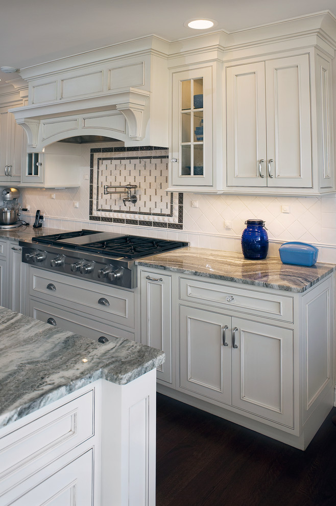 Example of a large classic u-shaped eat-in kitchen design in New York with an undermount sink, beaded inset cabinets, white cabinets, quartzite countertops, white backsplash, porcelain backsplash, stainless steel appliances and an island