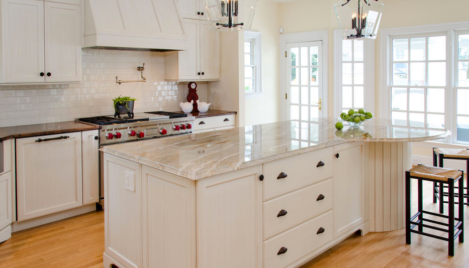 Example of a mid-sized country l-shaped light wood floor open concept kitchen design in Chicago with shaker cabinets, white cabinets, marble countertops, white backsplash, subway tile backsplash, stainless steel appliances and an island