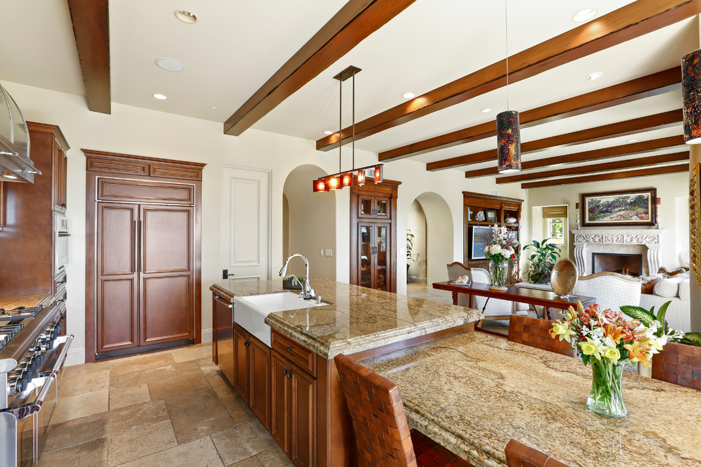 Mid-sized tuscan galley limestone floor and beige floor open concept kitchen photo in Orange County with a farmhouse sink, recessed-panel cabinets, medium tone wood cabinets, granite countertops, yellow backsplash, mosaic tile backsplash, paneled appliances and an island