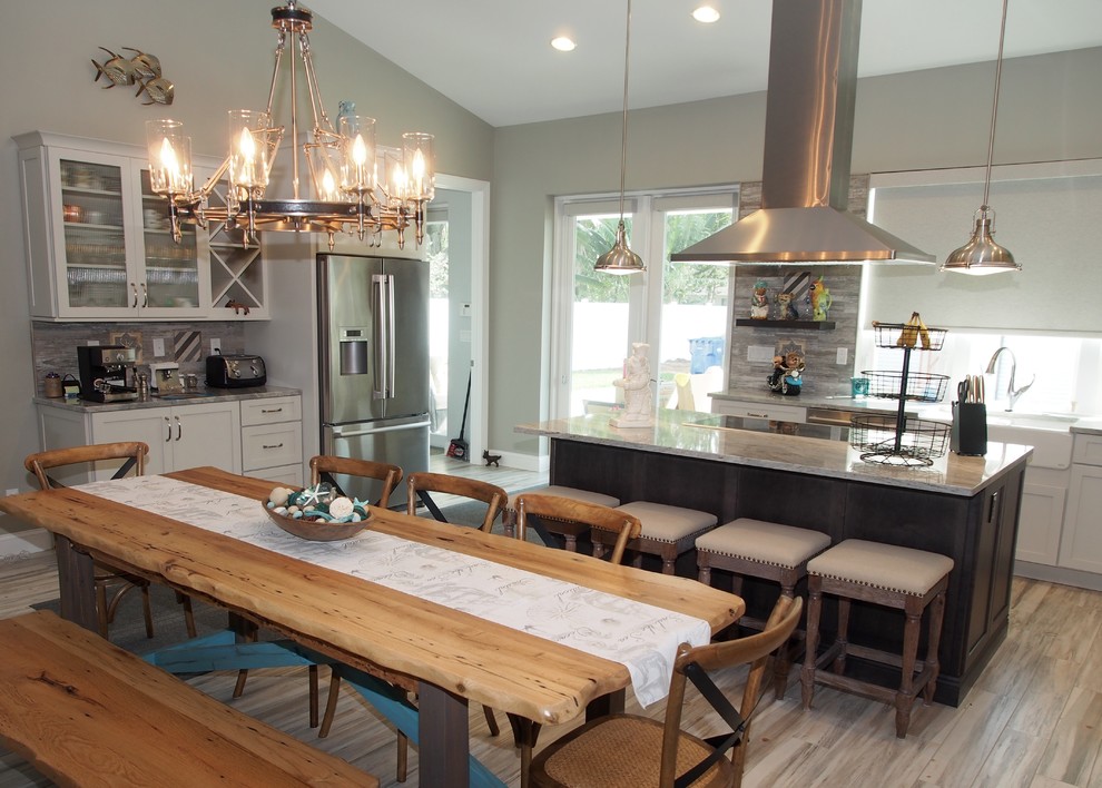 Inspiration for a large eat-in kitchen remodel in Tampa with shaker cabinets, white cabinets and an island