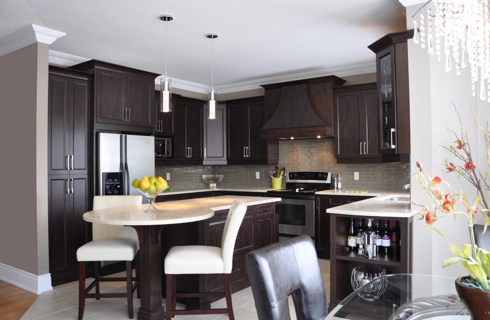 Design ideas for a large traditional u-shaped open plan kitchen in Ottawa with a submerged sink, shaker cabinets, dark wood cabinets, granite worktops, beige splashback, glass tiled splashback, stainless steel appliances, ceramic flooring and an island.