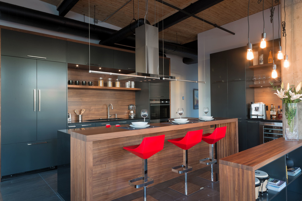 Kitchen - industrial kitchen idea in Montreal with an island