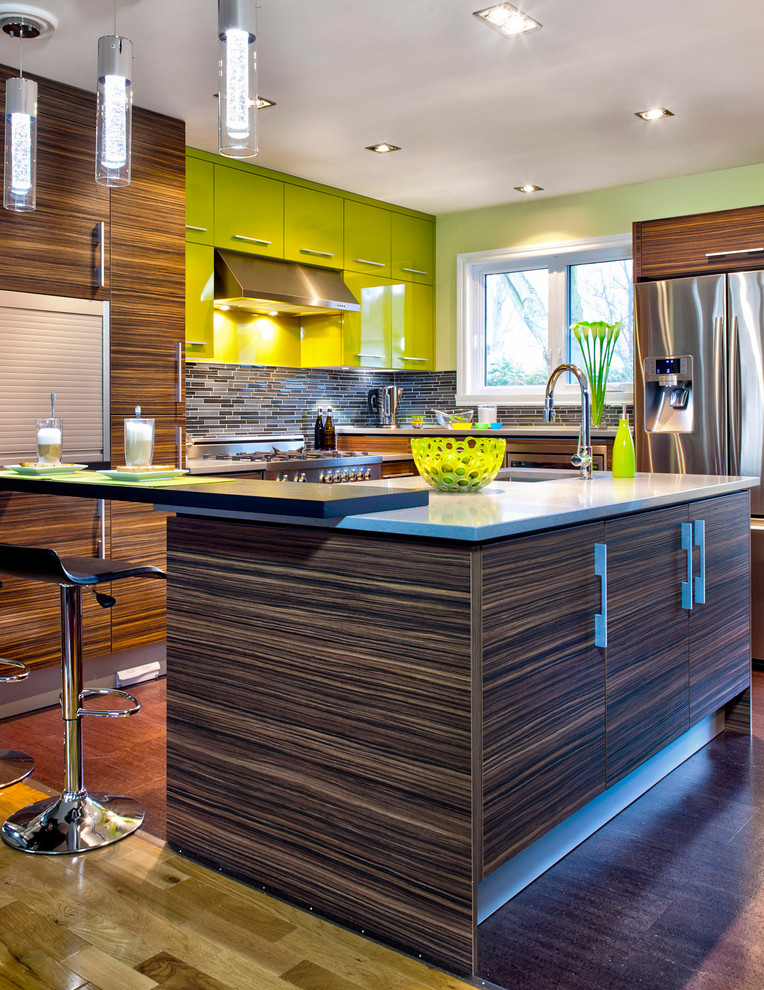 モントリオールにあるコンテンポラリースタイルのおしゃれなキッチン (フラットパネル扉のキャビネット、緑のキャビネット、ボーダータイルのキッチンパネル、シルバーの調理設備) の写真