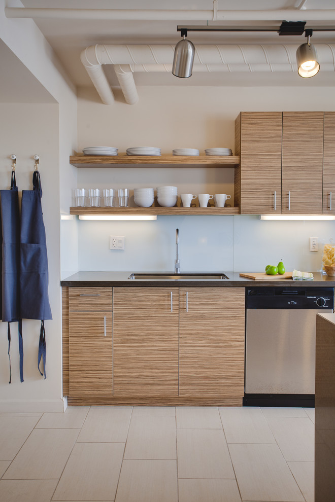 Small trendy porcelain tile open concept kitchen photo in Phoenix with an undermount sink, flat-panel cabinets, medium tone wood cabinets, stainless steel appliances, quartz countertops, white backsplash, glass sheet backsplash and an island
