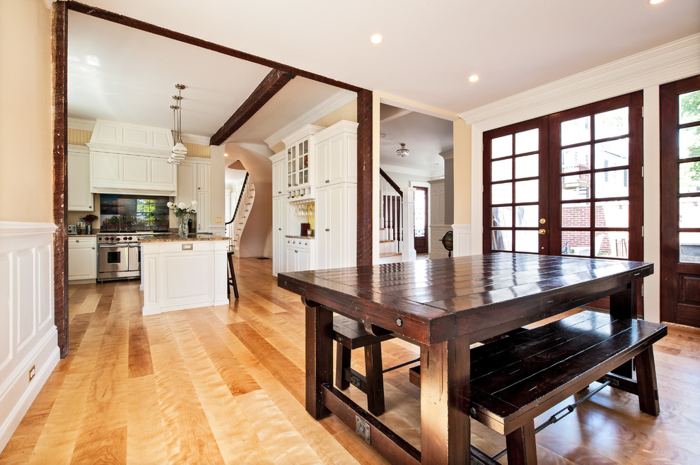 Example of a large ornate l-shaped light wood floor eat-in kitchen design in Boston with raised-panel cabinets, white cabinets, marble countertops, stainless steel appliances, an island and brown backsplash