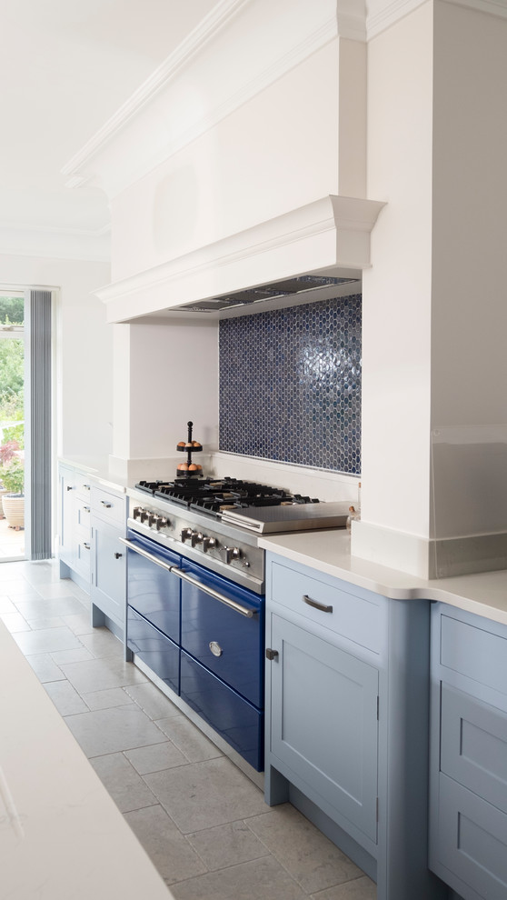 Inspiration for a large classic single-wall open plan kitchen in Cardiff with shaker cabinets, blue cabinets, quartz worktops, blue splashback, mosaic tiled splashback, coloured appliances, limestone flooring, an island and grey floors.