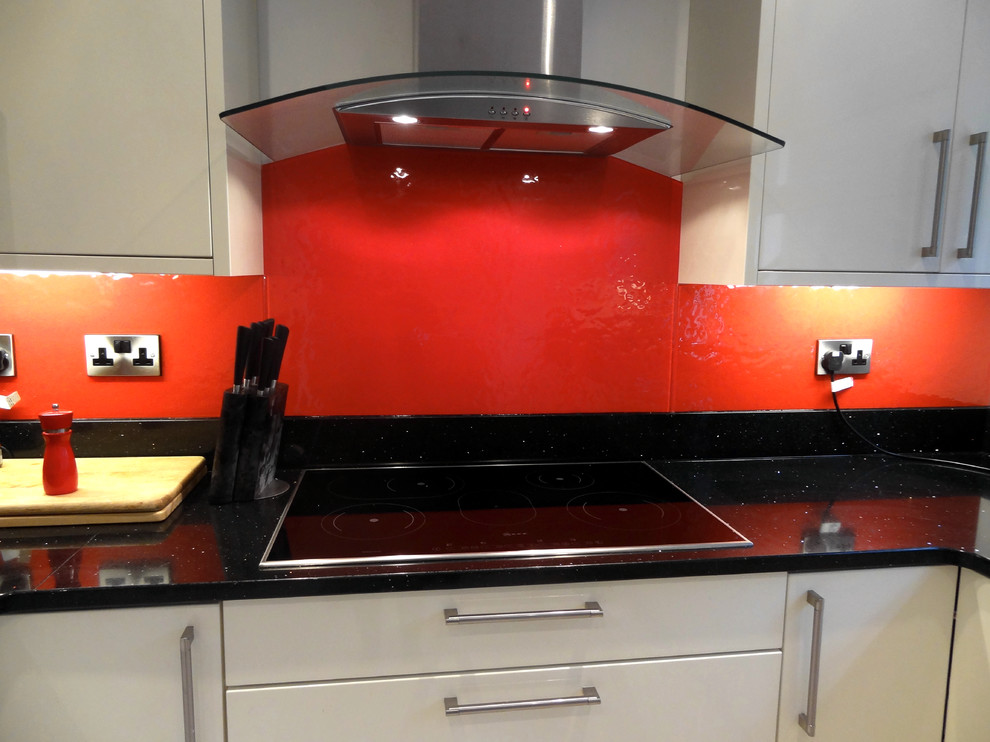 Example of a trendy u-shaped ceramic tile kitchen design in Other with flat-panel cabinets, white cabinets, red backsplash and no island