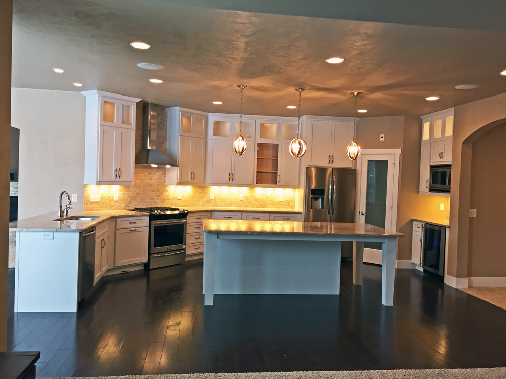 Eat-in kitchen - large contemporary u-shaped dark wood floor eat-in kitchen idea in Other with an undermount sink, shaker cabinets, white cabinets, granite countertops, multicolored backsplash, ceramic backsplash, stainless steel appliances and two islands