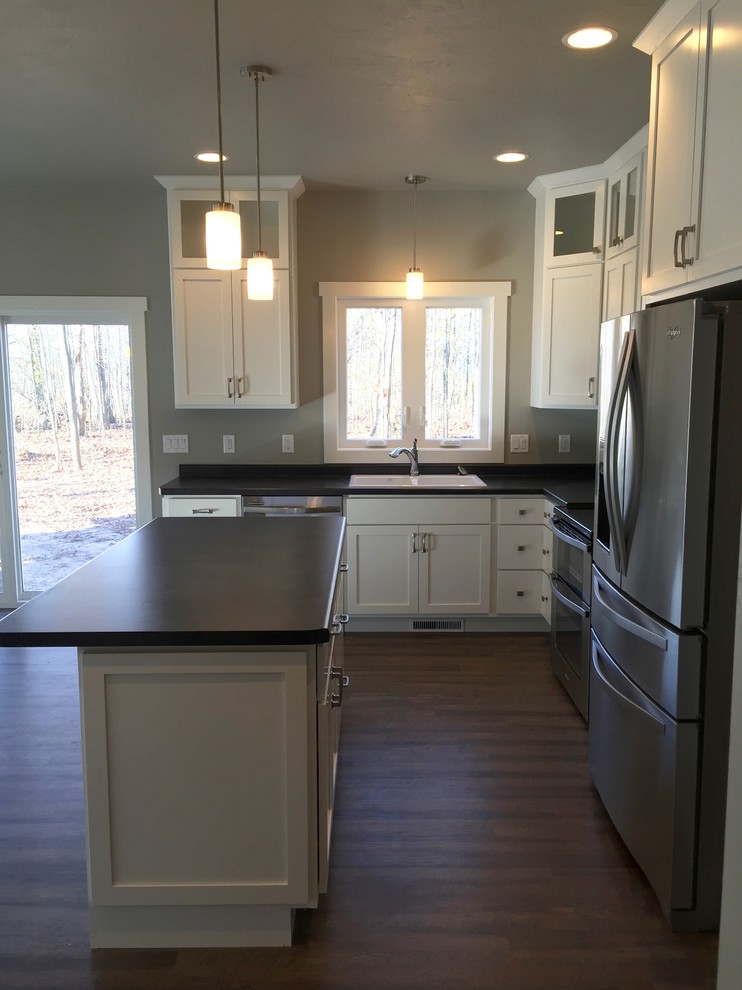 Eat-in kitchen - mid-sized craftsman u-shaped vinyl floor eat-in kitchen idea in Other with a drop-in sink, shaker cabinets, white cabinets, stainless steel appliances and an island