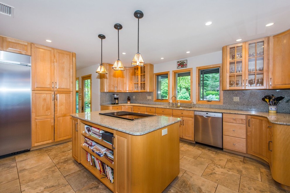 Large transitional light wood floor, brown floor and vaulted ceiling eat-in kitchen photo in New York with a double-bowl sink, raised-panel cabinets, light wood cabinets, granite countertops, multicolored backsplash, granite backsplash, stainless steel appliances, an island and multicolored countertops