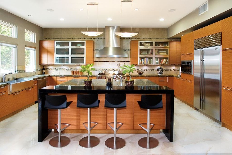 This is an example of a contemporary u-shaped kitchen in Orange County with a belfast sink, flat-panel cabinets, medium wood cabinets, multi-coloured splashback, stainless steel appliances and an island.