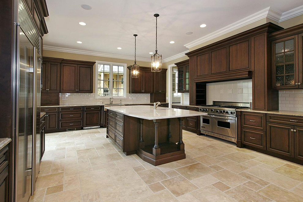 Inspiration for a large transitional u-shaped travertine floor and beige floor open concept kitchen remodel in Phoenix with a farmhouse sink, recessed-panel cabinets, medium tone wood cabinets, marble countertops, white backsplash, subway tile backsplash, stainless steel appliances and an island