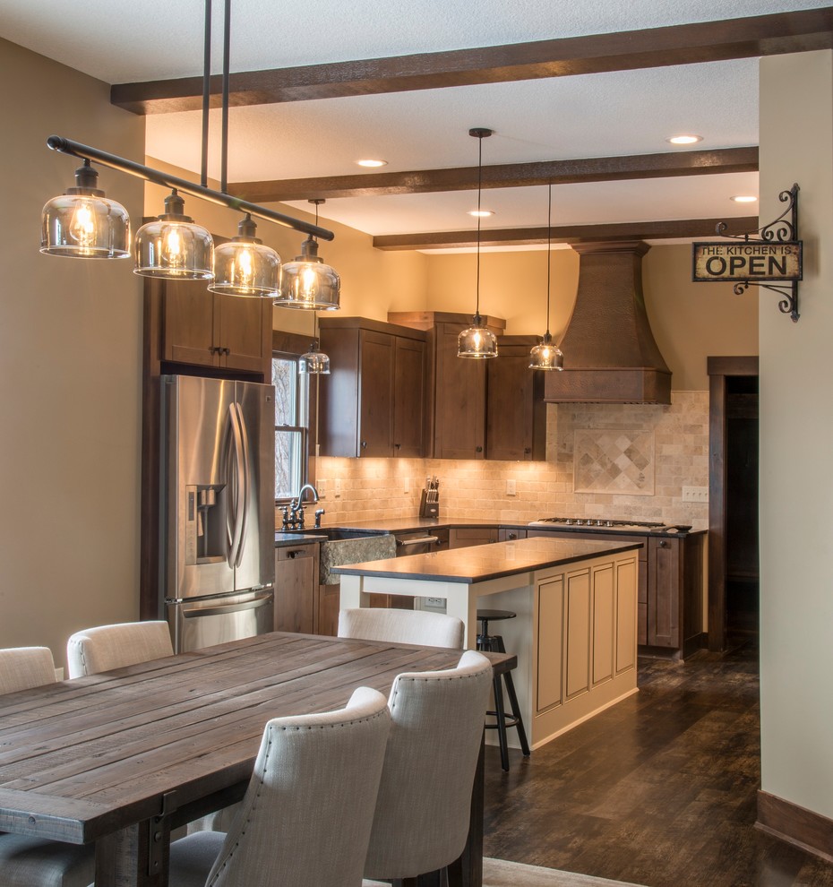 Mid-sized galley laminate floor and brown floor eat-in kitchen photo in Dallas with flat-panel cabinets, brown cabinets, granite countertops, beige backsplash, ceramic backsplash, stainless steel appliances, an island and brown countertops