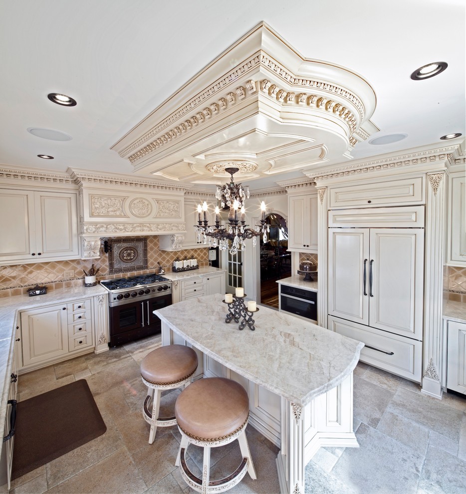 Enclosed kitchen - large traditional u-shaped porcelain tile and beige floor enclosed kitchen idea in New York with an undermount sink, raised-panel cabinets, beige cabinets, marble countertops, paneled appliances, an island, multicolored backsplash, mosaic tile backsplash and white countertops