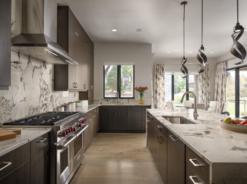 Inspiration for a large contemporary l-shaped light wood floor and brown floor open concept kitchen remodel in Denver with an undermount sink, flat-panel cabinets, dark wood cabinets, granite countertops, stainless steel appliances, an island, gray backsplash and gray countertops