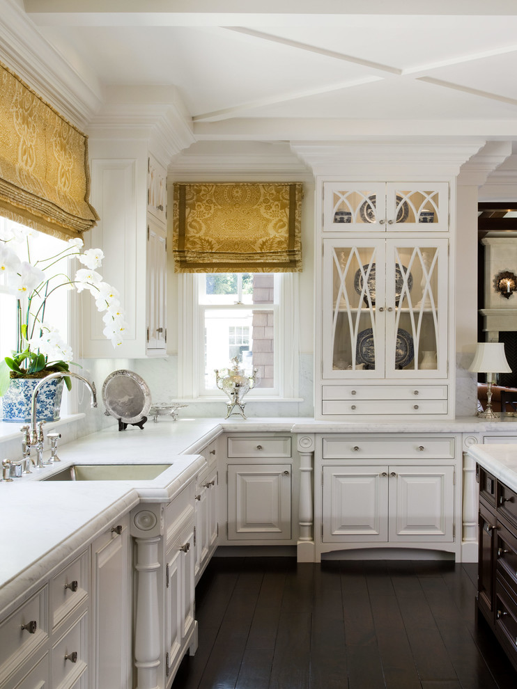 Elegant kitchen photo in San Francisco with glass-front cabinets and an undermount sink