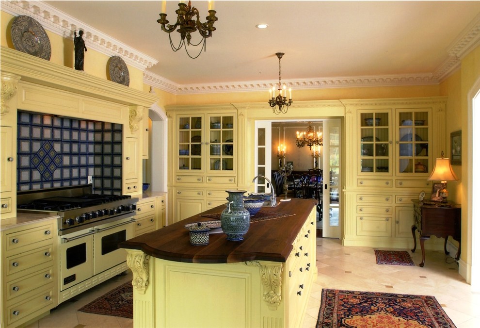 Идея дизайна: отдельная кухня в классическом стиле с желтыми фасадами, деревянной столешницей, цветной техникой, фасадами с выступающей филенкой и разноцветным фартуком