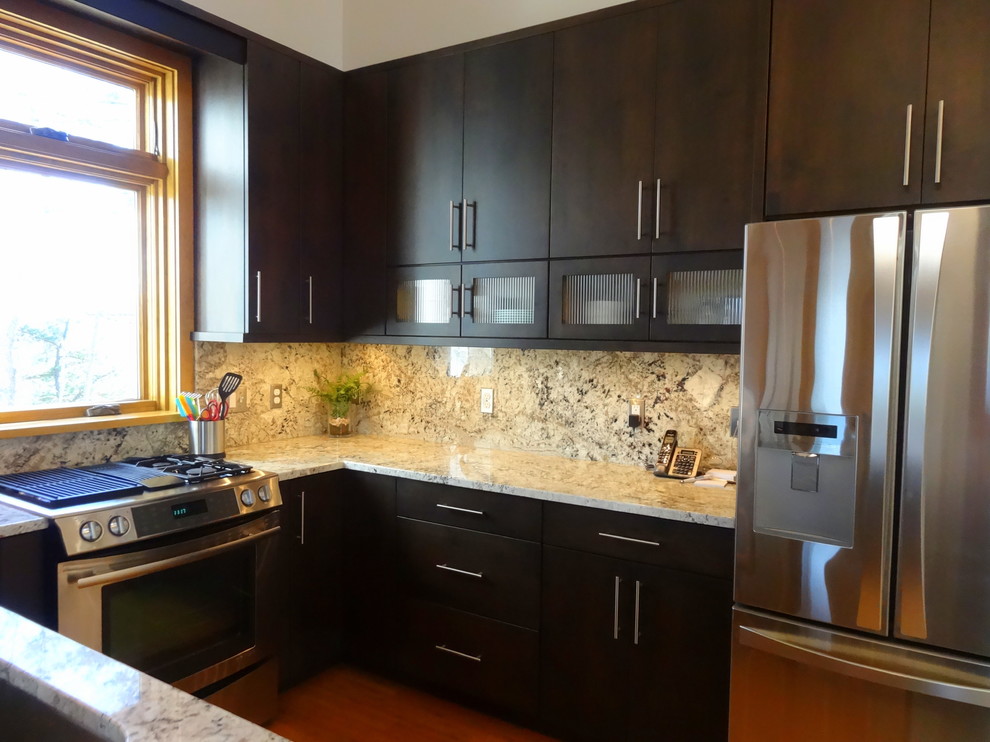 Example of a mid-sized trendy u-shaped medium tone wood floor eat-in kitchen design in Charlotte with a single-bowl sink, flat-panel cabinets, dark wood cabinets, granite countertops, multicolored backsplash, stone slab backsplash, stainless steel appliances and no island