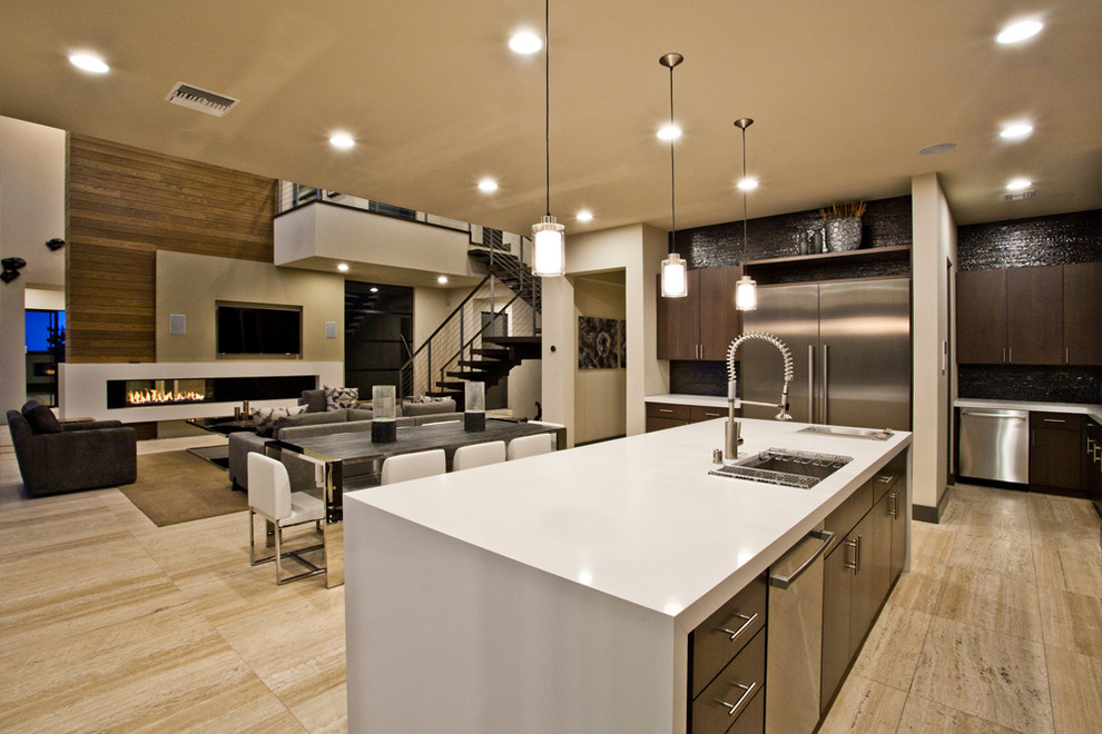 Inspiration for a large contemporary galley beige floor open concept kitchen remodel in Las Vegas with an undermount sink, dark wood cabinets, solid surface countertops, black backsplash, stainless steel appliances, an island and white countertops