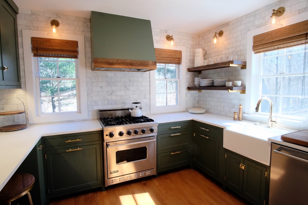 Inspiration for a small country u-shaped medium tone wood floor and brown floor enclosed kitchen remodel in New York with a farmhouse sink, shaker cabinets, green cabinets, marble countertops, white backsplash, ceramic backsplash, stainless steel appliances, no island and white countertops