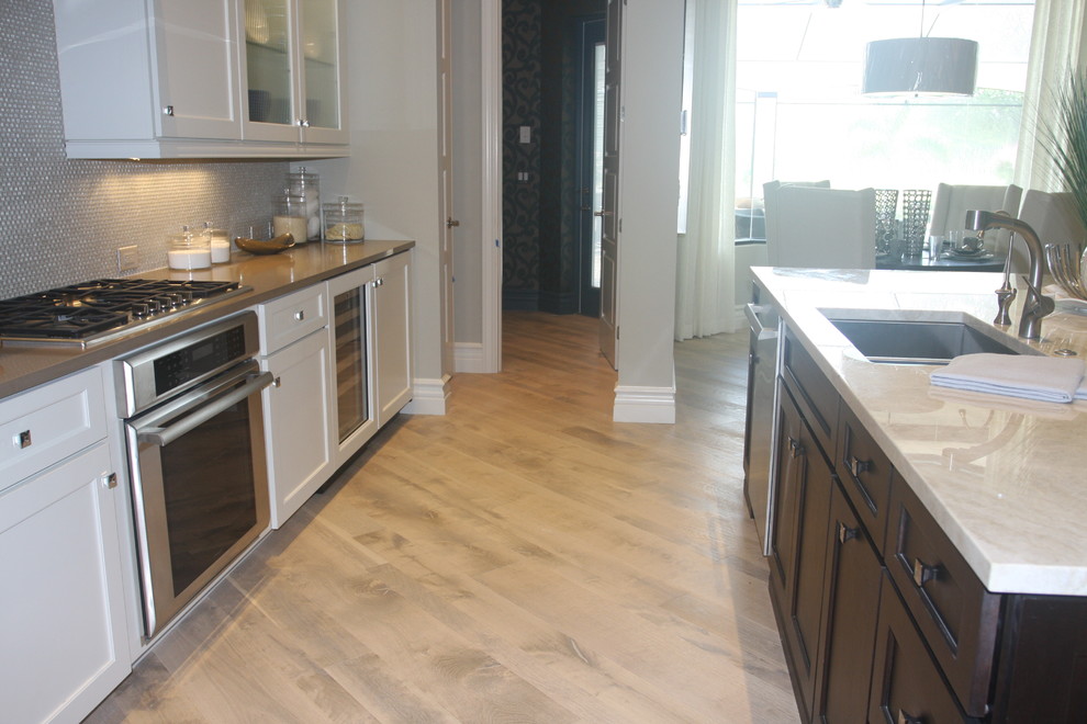Inspiration for a traditional kitchen in Miami with medium hardwood flooring.