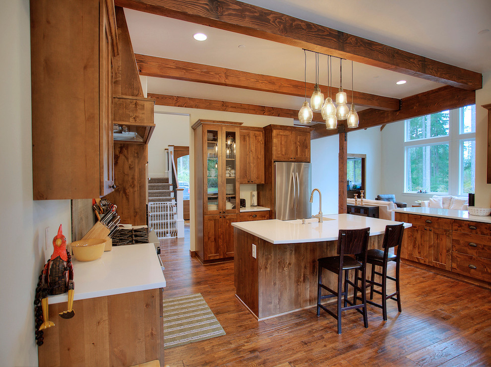 Example of a large classic medium tone wood floor open concept kitchen design in Seattle with a farmhouse sink, glass-front cabinets, medium tone wood cabinets, quartzite countertops, stainless steel appliances and an island