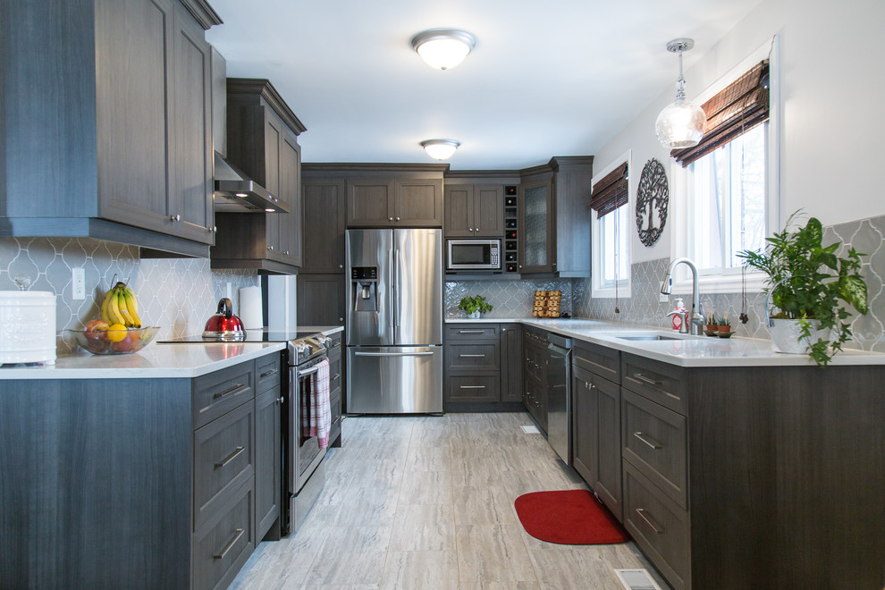 This is an example of a medium sized classic galley enclosed kitchen in Toronto with a submerged sink, recessed-panel cabinets, dark wood cabinets, quartz worktops, grey splashback, ceramic splashback, stainless steel appliances, porcelain flooring, no island, beige floors and white worktops.