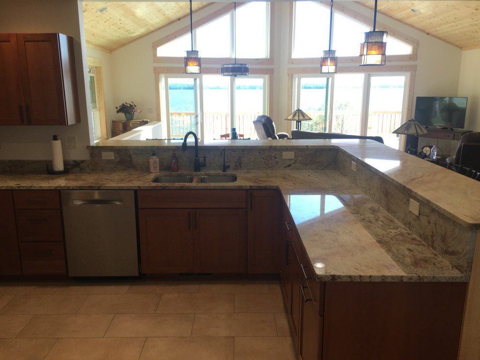 Mid-sized elegant u-shaped porcelain tile and beige floor open concept kitchen photo in Other with an undermount sink, shaker cabinets, medium tone wood cabinets, granite countertops, stainless steel appliances, a peninsula and gray countertops